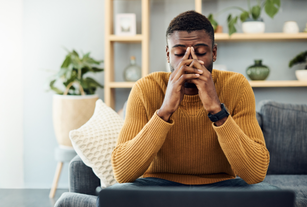 burnout vs. depression, a man with his head in his hands, visually representing burnout